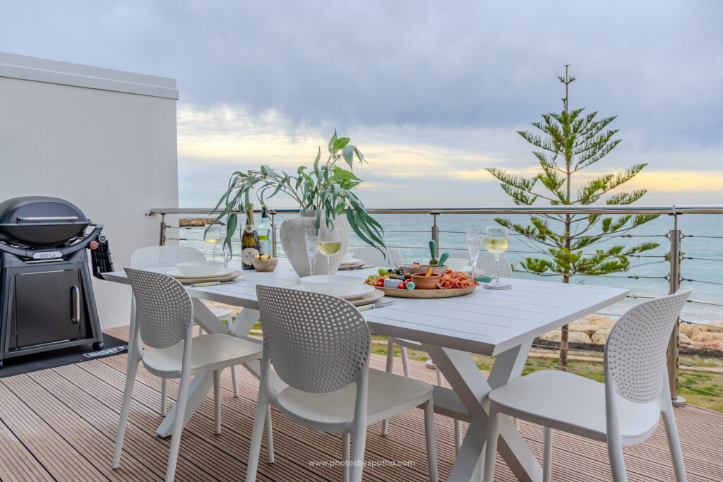 Rooftop dining setup overlooking the ocean at Sea Breeze Villa, Mandurah